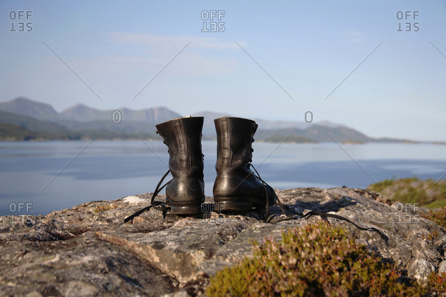 Hiking boots on cliff by the sea