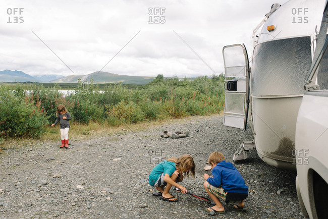 Children playing outside next to their camper trailer in Denali, Alaska
