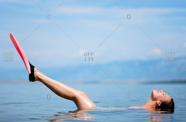 Woman swimming with flippers at beach