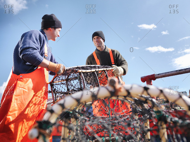 Fishermen loading boat with lobster pots