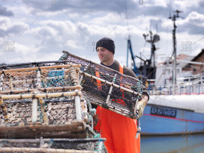 Fisherman loading lobster pots - Offset