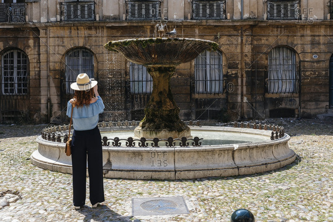 Woman photographing the Place D' Albertas, Aix-en-Provence, France