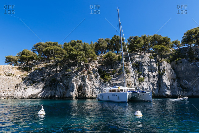 Catamaran moored along the coastline near Calanque d'en Vau