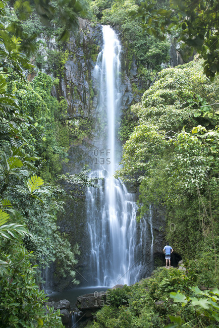 Man admiring Wailua Falls, along the famed Road to Hana in Maui, Hawaii