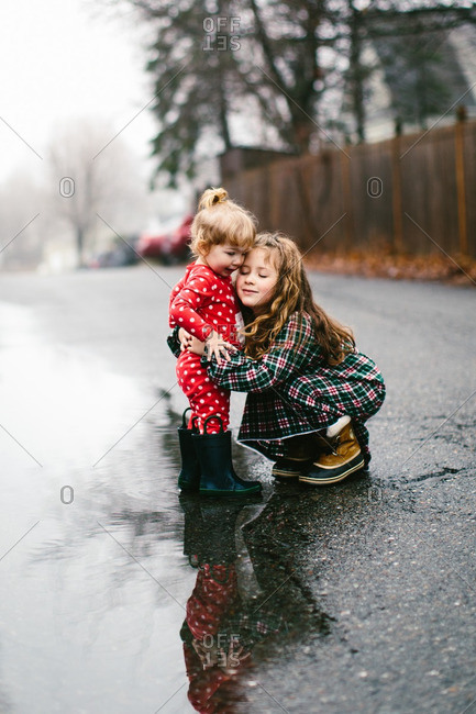 Sisters hugging in fog