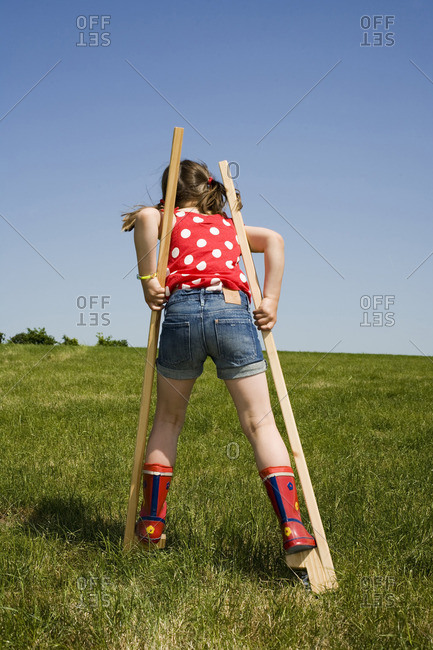 A young girl on stilts
