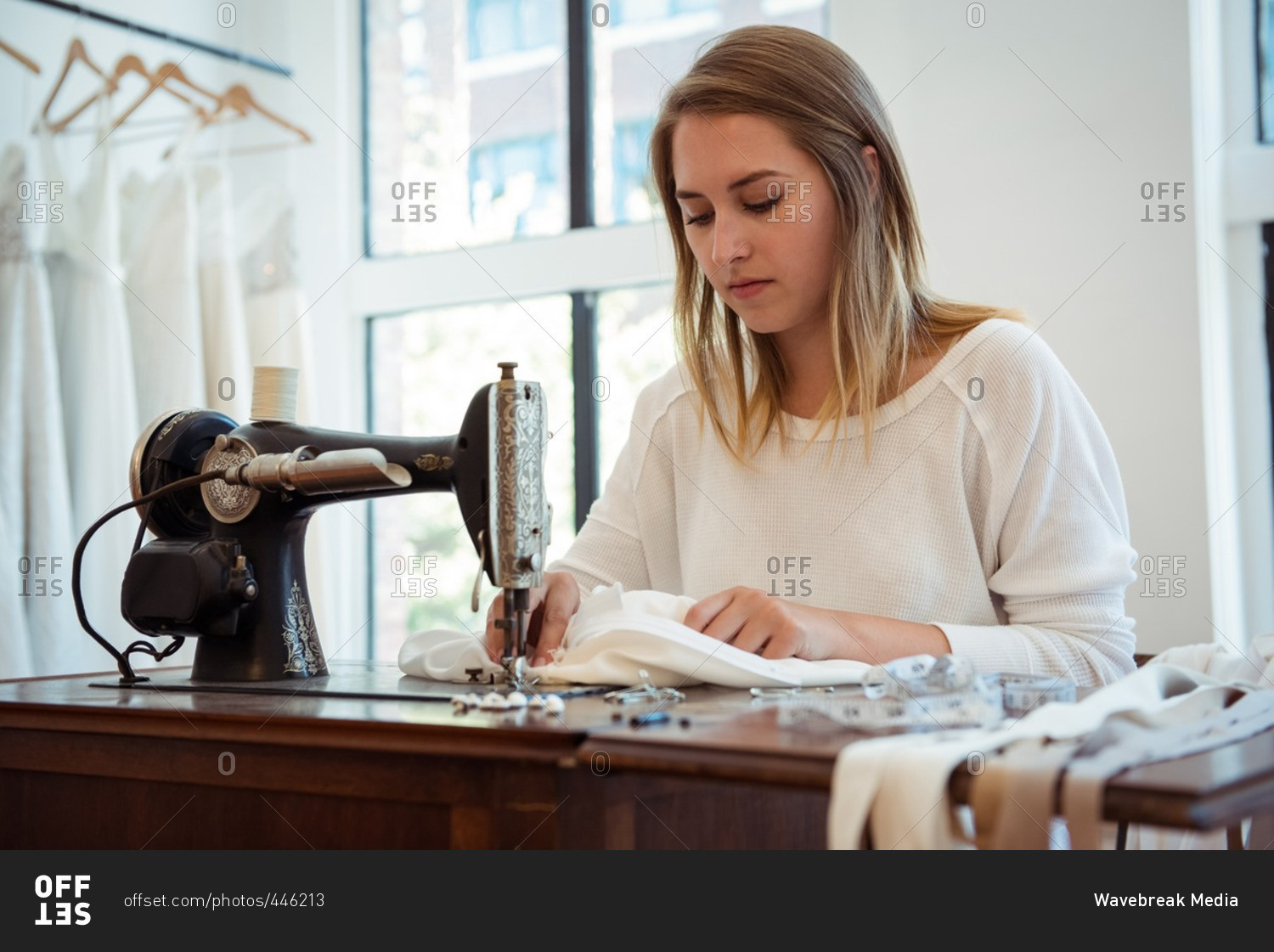 Dressmaker With Sewing Machine In Her Studio Stock Photo, Picture