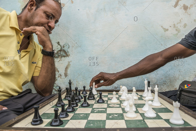 The little boy ponders the next chess move. Stock Photo