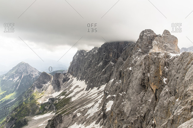 Dachstein, Styria, Austria - June 29, 2015: Professional highline athlete Reinhard Kleindl and his crew on a special alpine highline project in the Austrian alps. This project is set almost at 3000 meters above see level. The project involves a difficult climbing access as well as special rigging skills