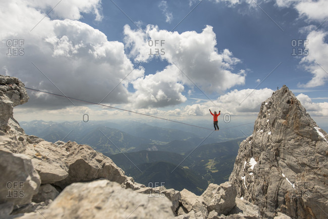 Dachstein, Styria, Austria - June 30, 2015: Professional highline athlete Reinhard Kleindl and his crew on a special alpine highline project in the Austrian alps. This project is set almost at 3000 meters above see level. The project involves a difficult climbing access as well as special rigging skills