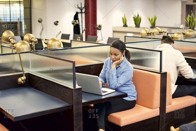 Office workers in booth seating