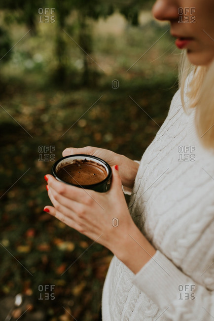 Woman carrying cup of hot chocolate outside