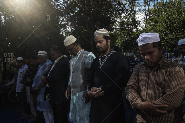 Rome, Italy - October 7, 2016: Islamic men praying outside