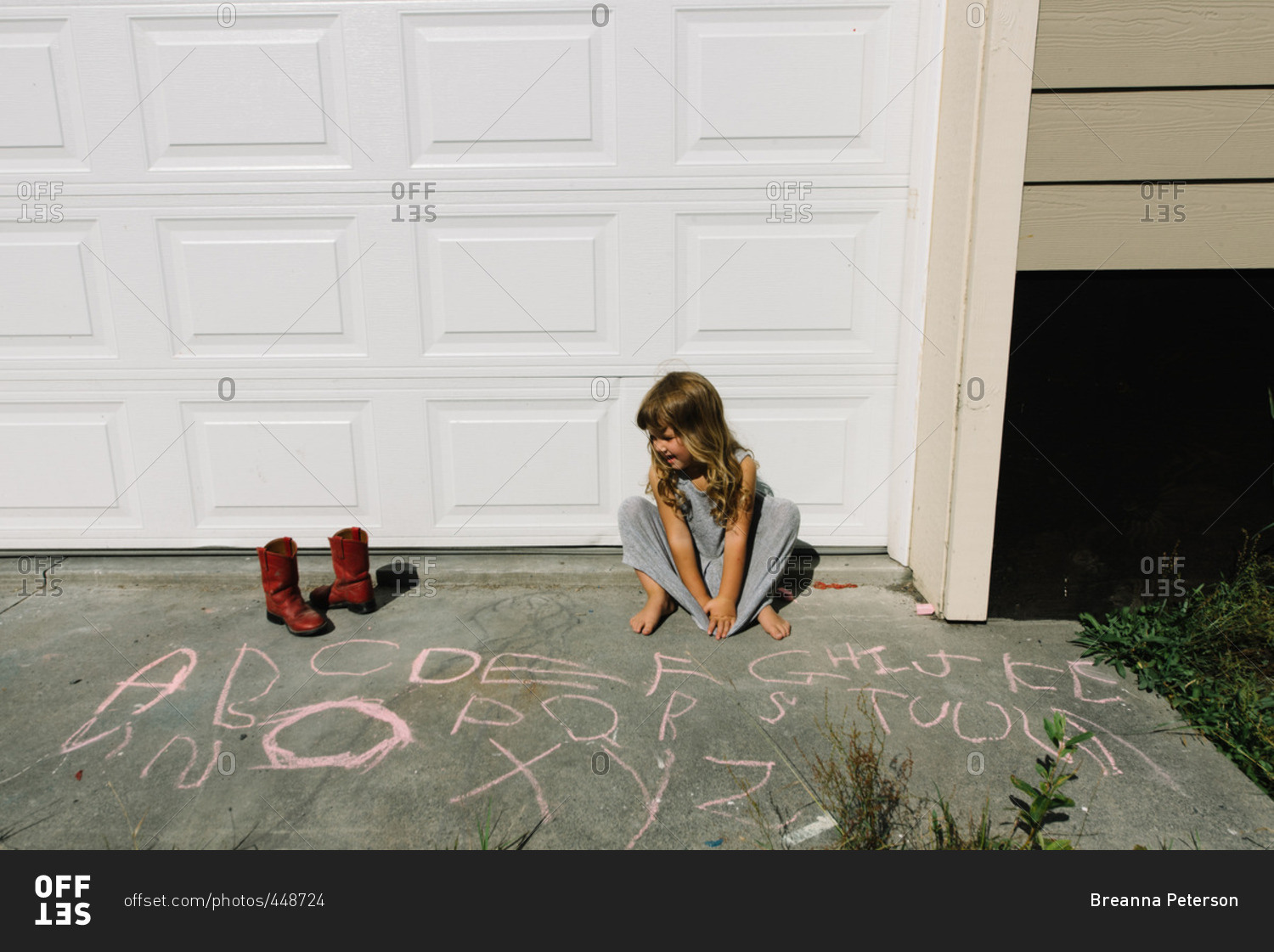 Girl drawing letters with chalk