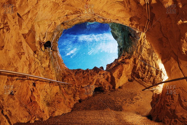 Blue sky through opening in cave