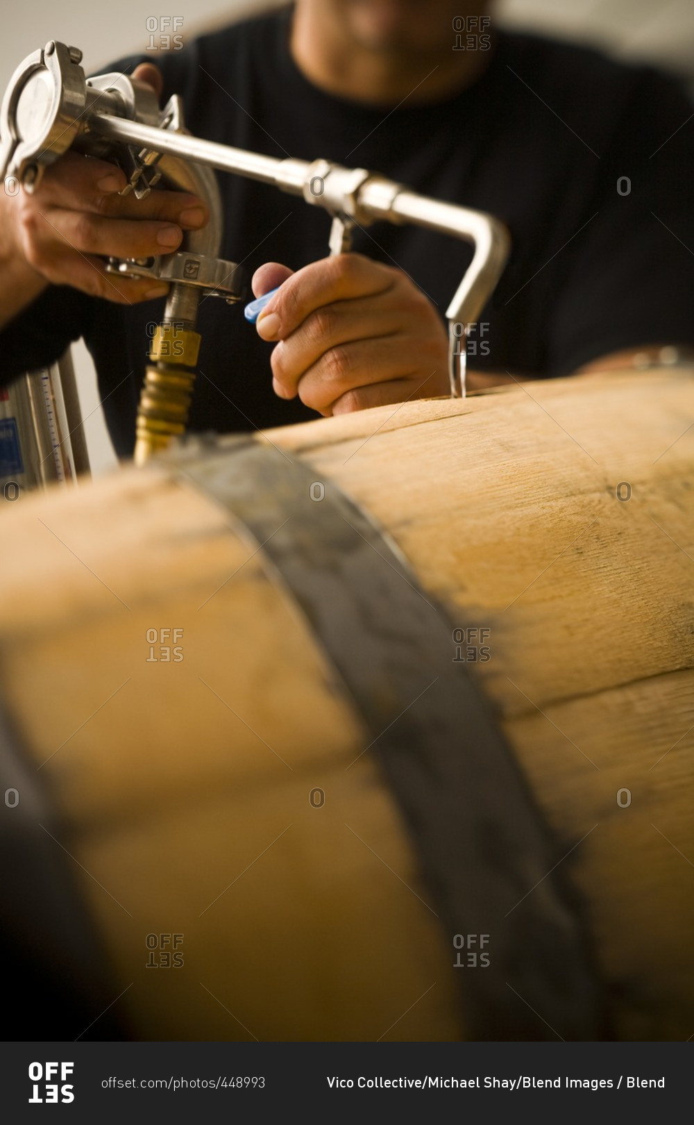Man pouring water into wooden keg