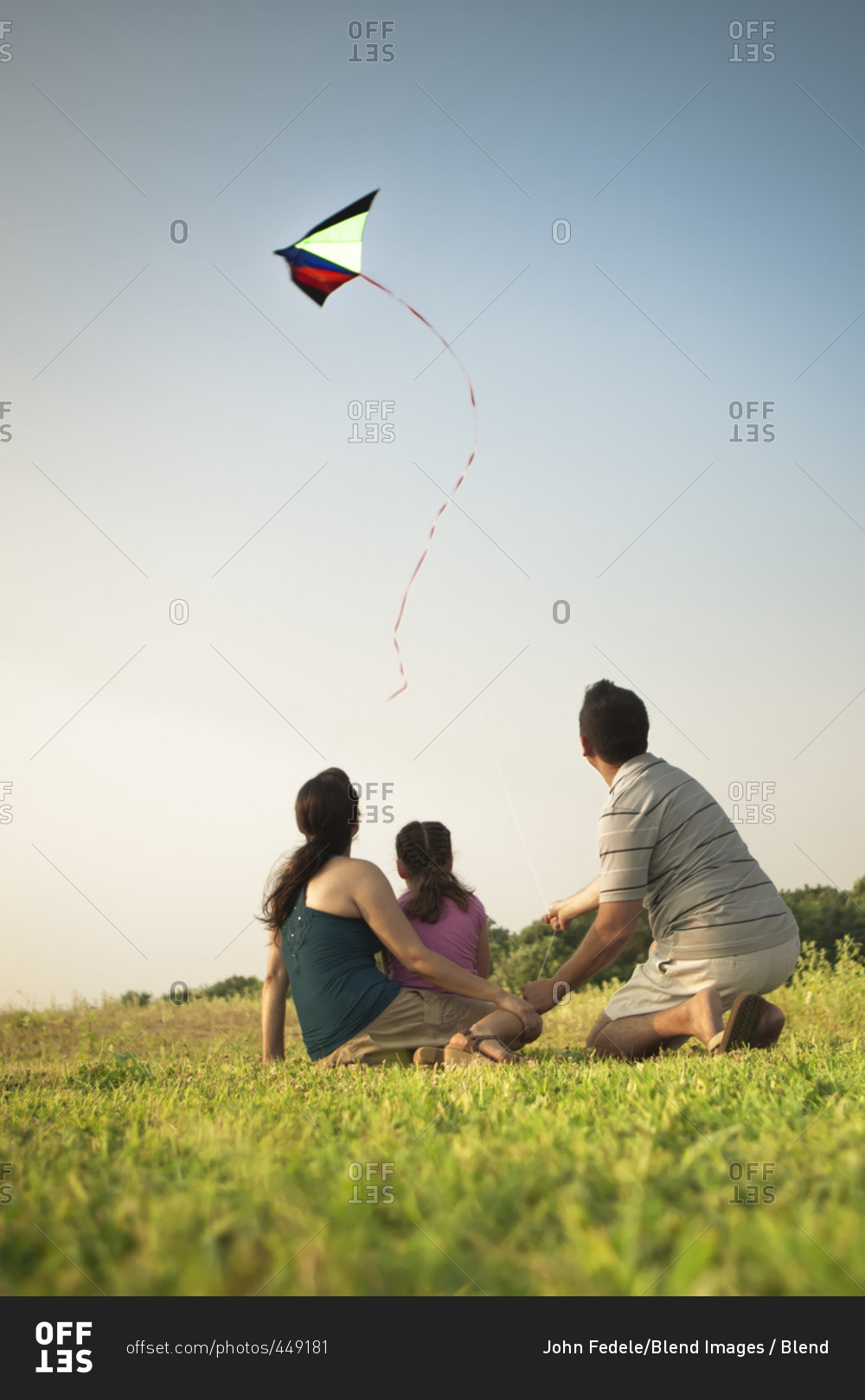 Family watching kite in sky