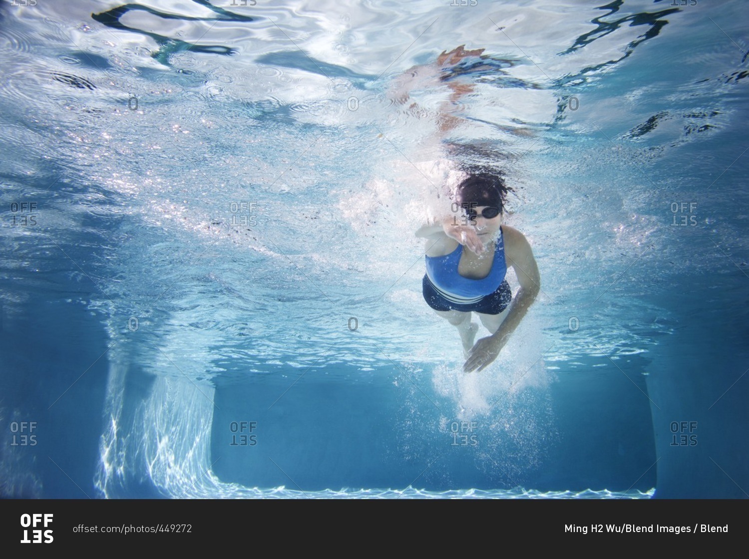 Caucasian woman swimming in swimming pool