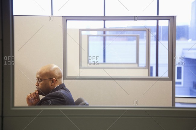 African American businessman working in office cubicle