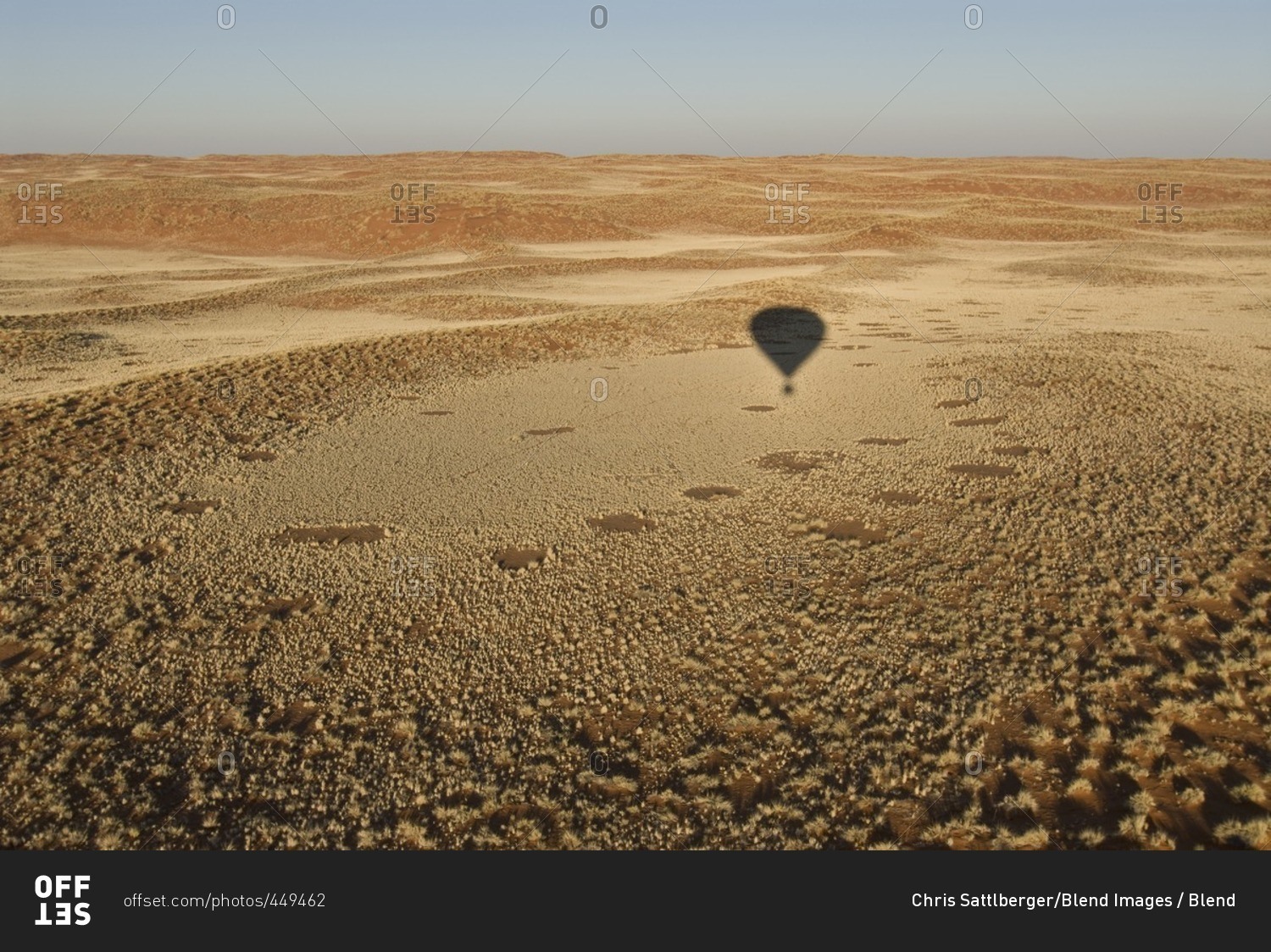 Shadow of hot air balloon over desert
