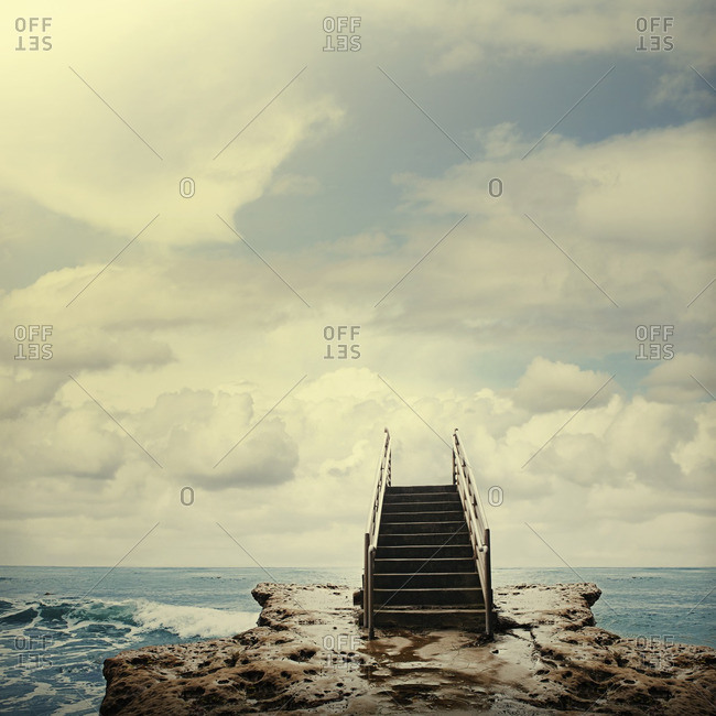 Stairs on rocks next to ocean