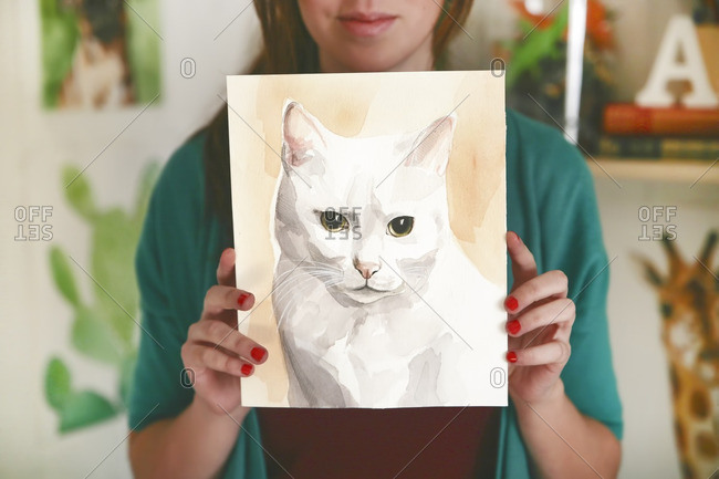 Artist showing aquarelle of a cat
