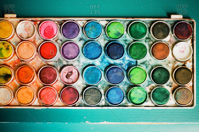 Messy tray of used watercolor paints stock photo - OFFSET