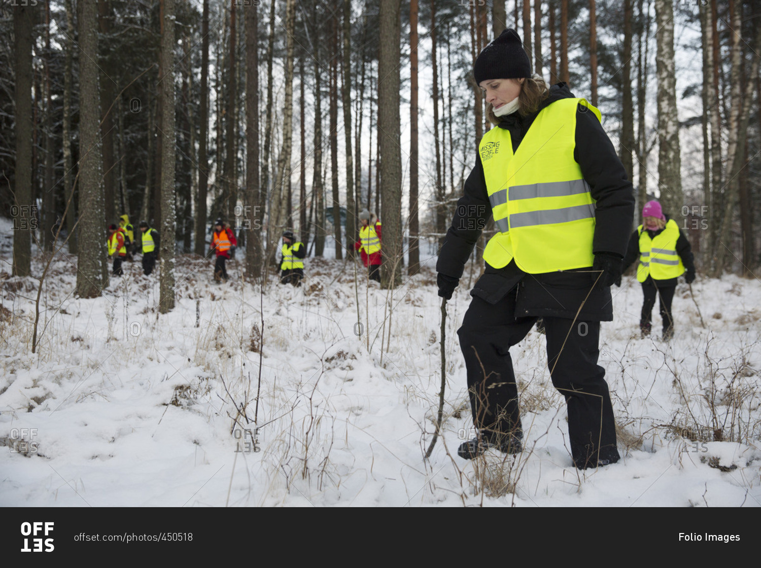 Sweden, Uppland, Upplands Vasby, Volunteers of Missing people organization in winter forest