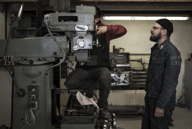 France, Men working in metal workshop