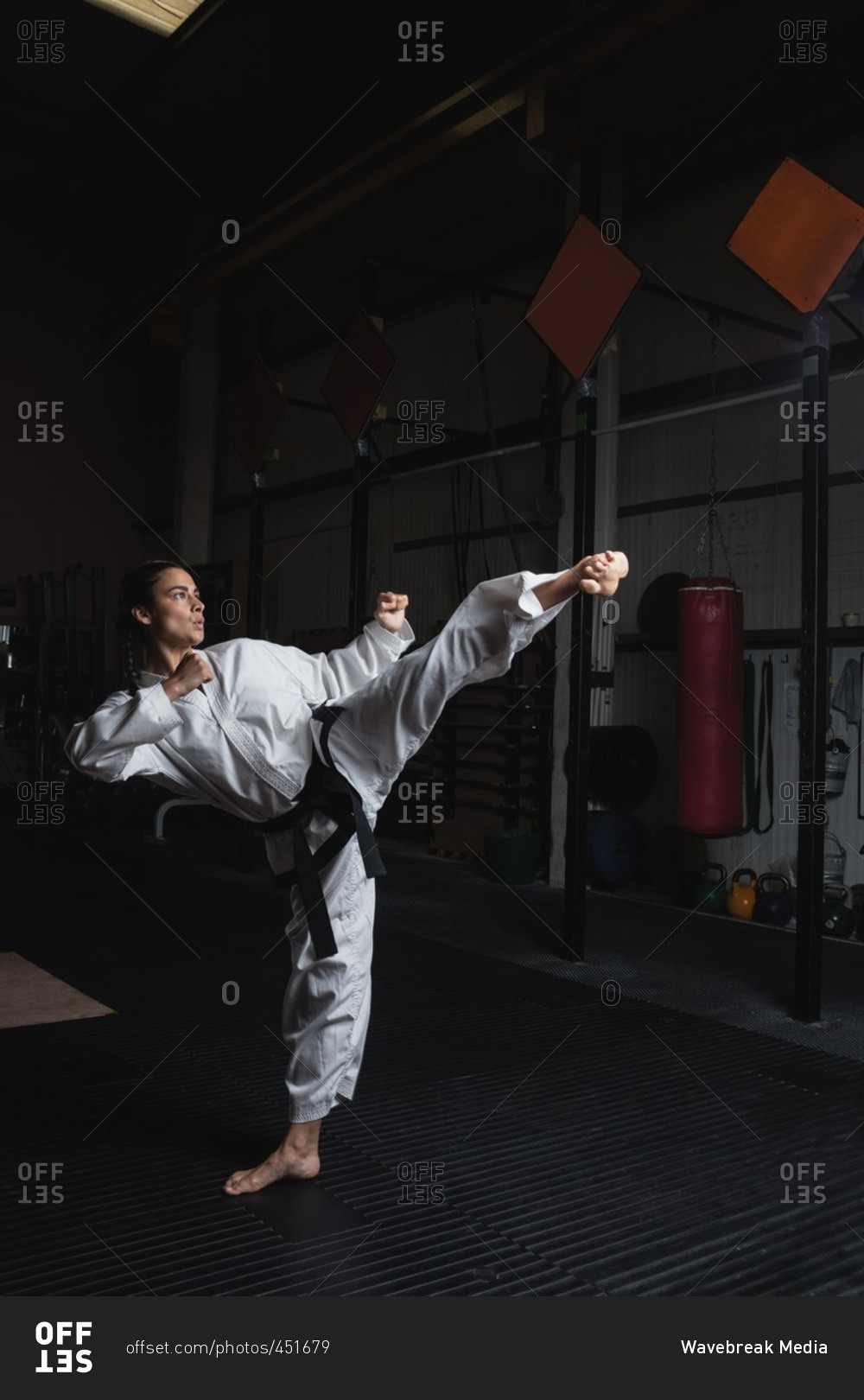 Woman practicing karate in fitness studio