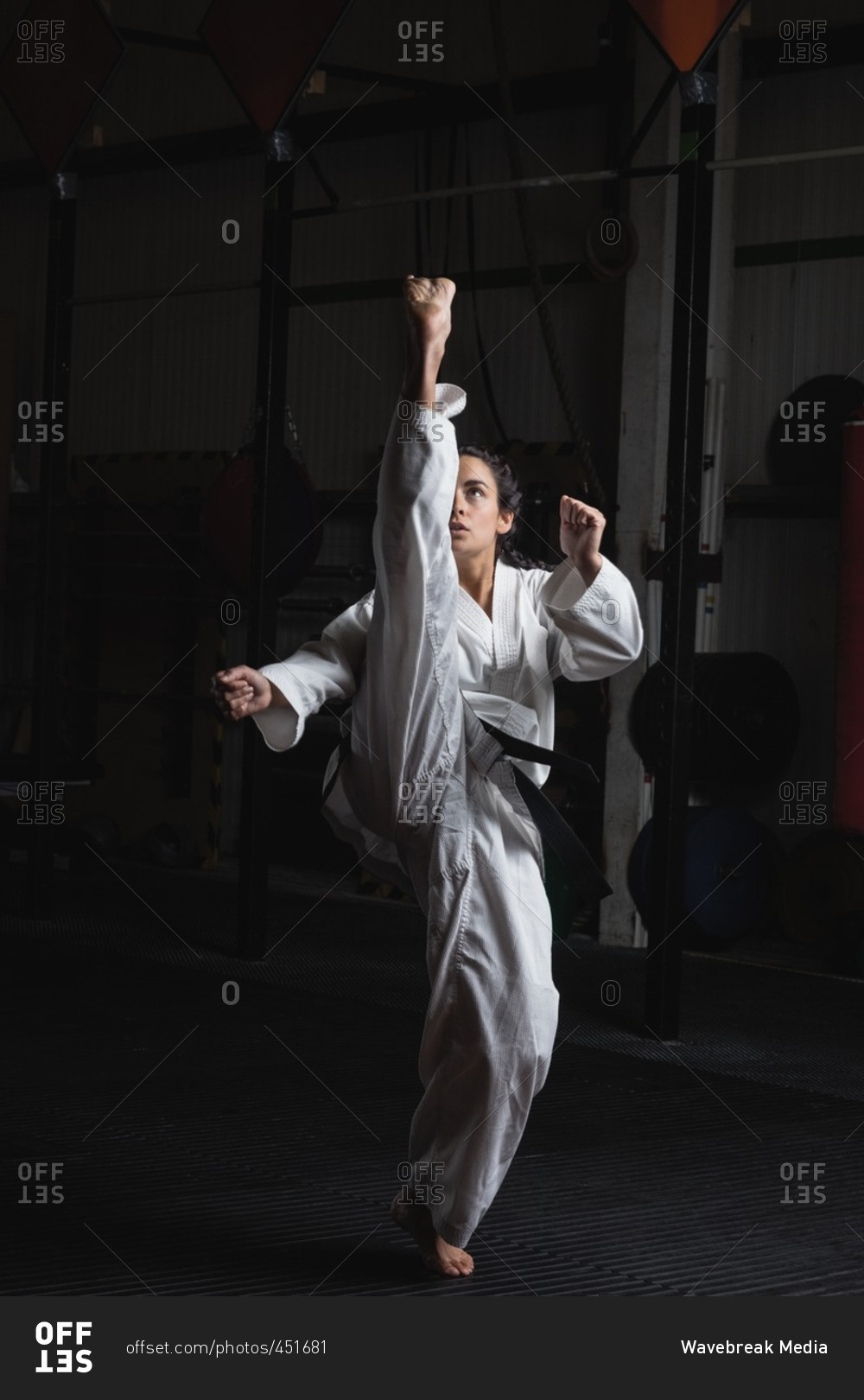Woman practicing karate in fitness studio