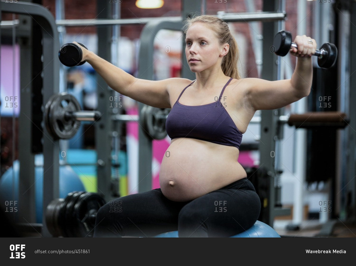 pregnant-woman-lifting-dumbbells-at-gym-stock-photo-offset