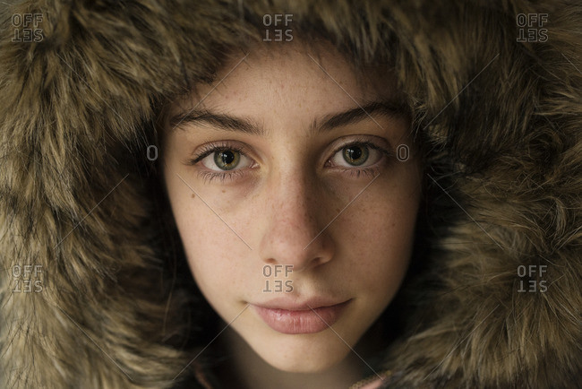Beautiful young girl in a fur hood