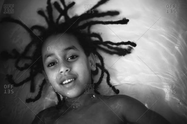 Little Girl With Dreadlocks In A Bath Stock Photo Offset
