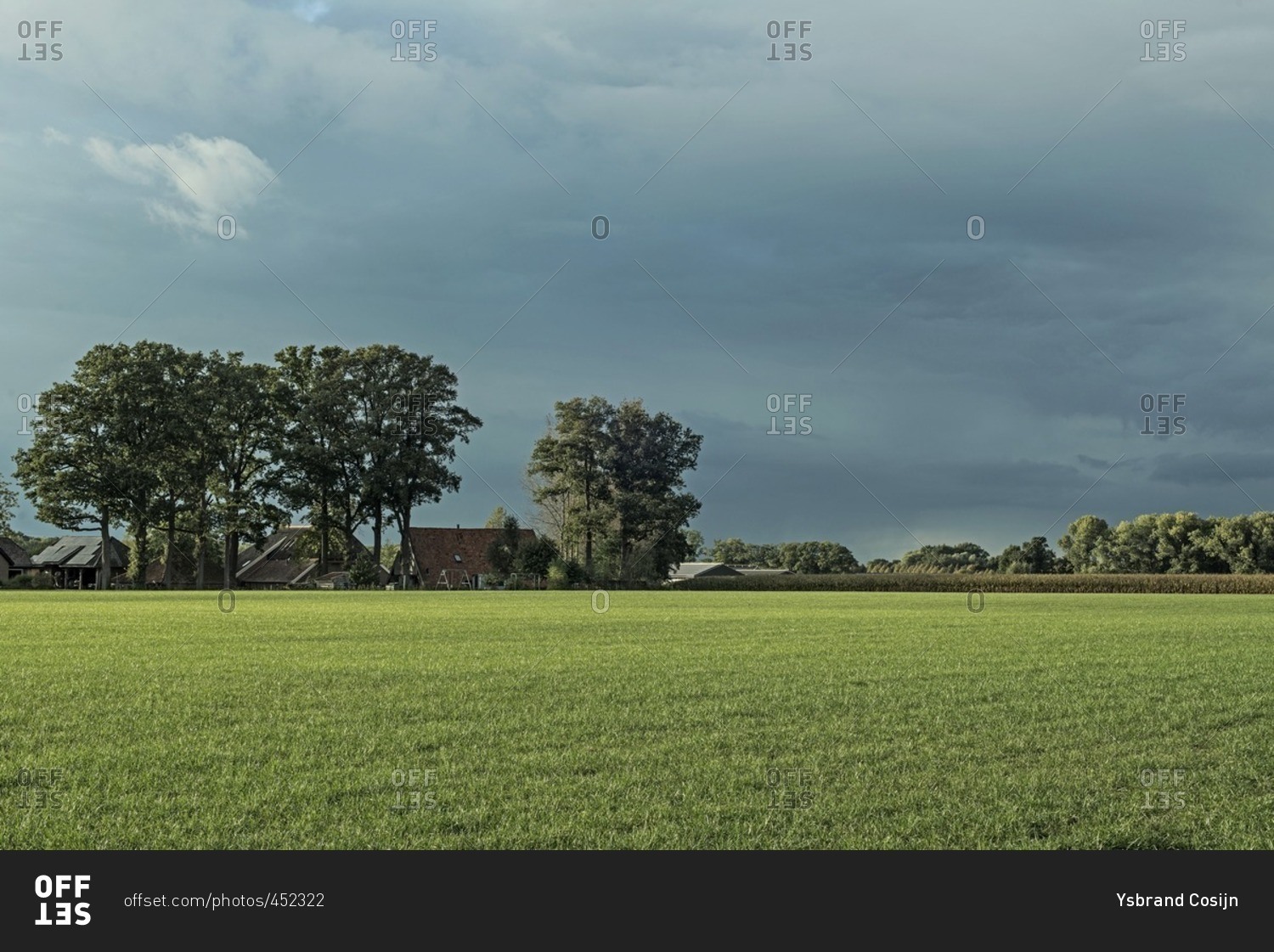 Dutch farmland with farm and trees under stormy sky, Achterhoek, Gelderland, The Netherlands