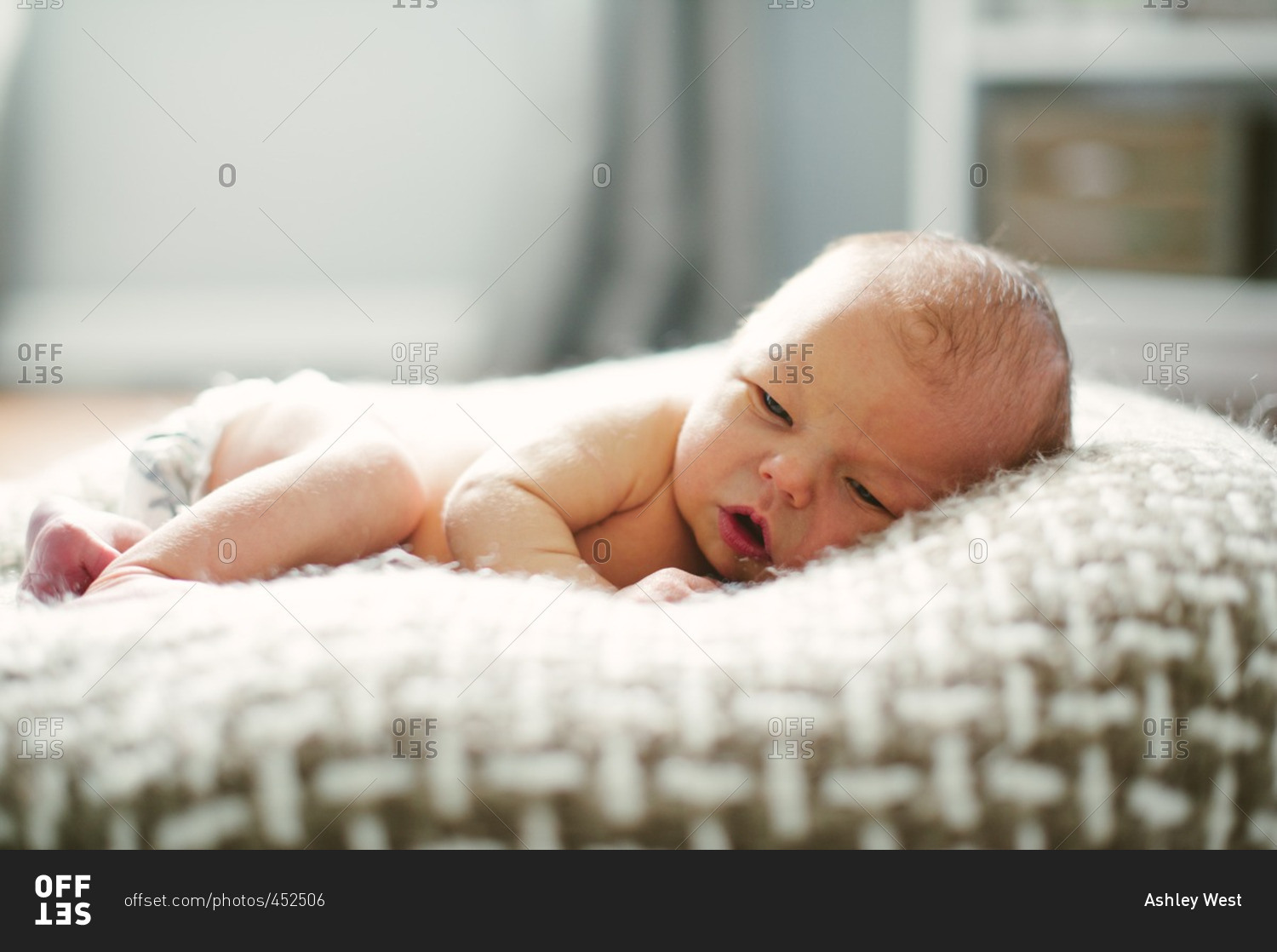 A newborn on a soft pillow stock photo OFFSET