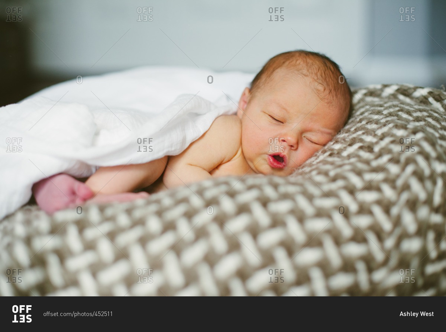 Newborn baby boy sleeping on a blanket stock photo - OFFSET