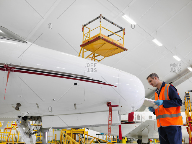 Engineer inspects jet aircraft