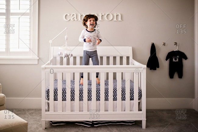 Toddler Boy Jumping In Crib Stock Photo Offset