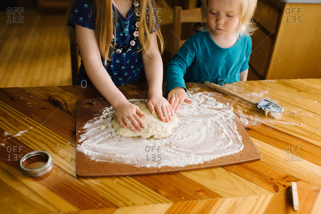 Girls making biscuit dough