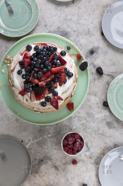 Pavlova cake served with berries on a table