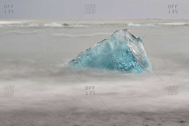 Chunk of ice on rocky beach, Iceland