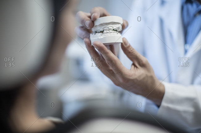 Orthodontist showing patient dental mold