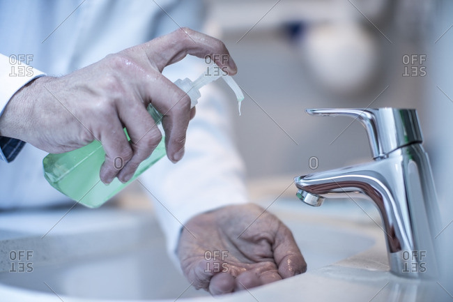 Doctor washing hands with soap