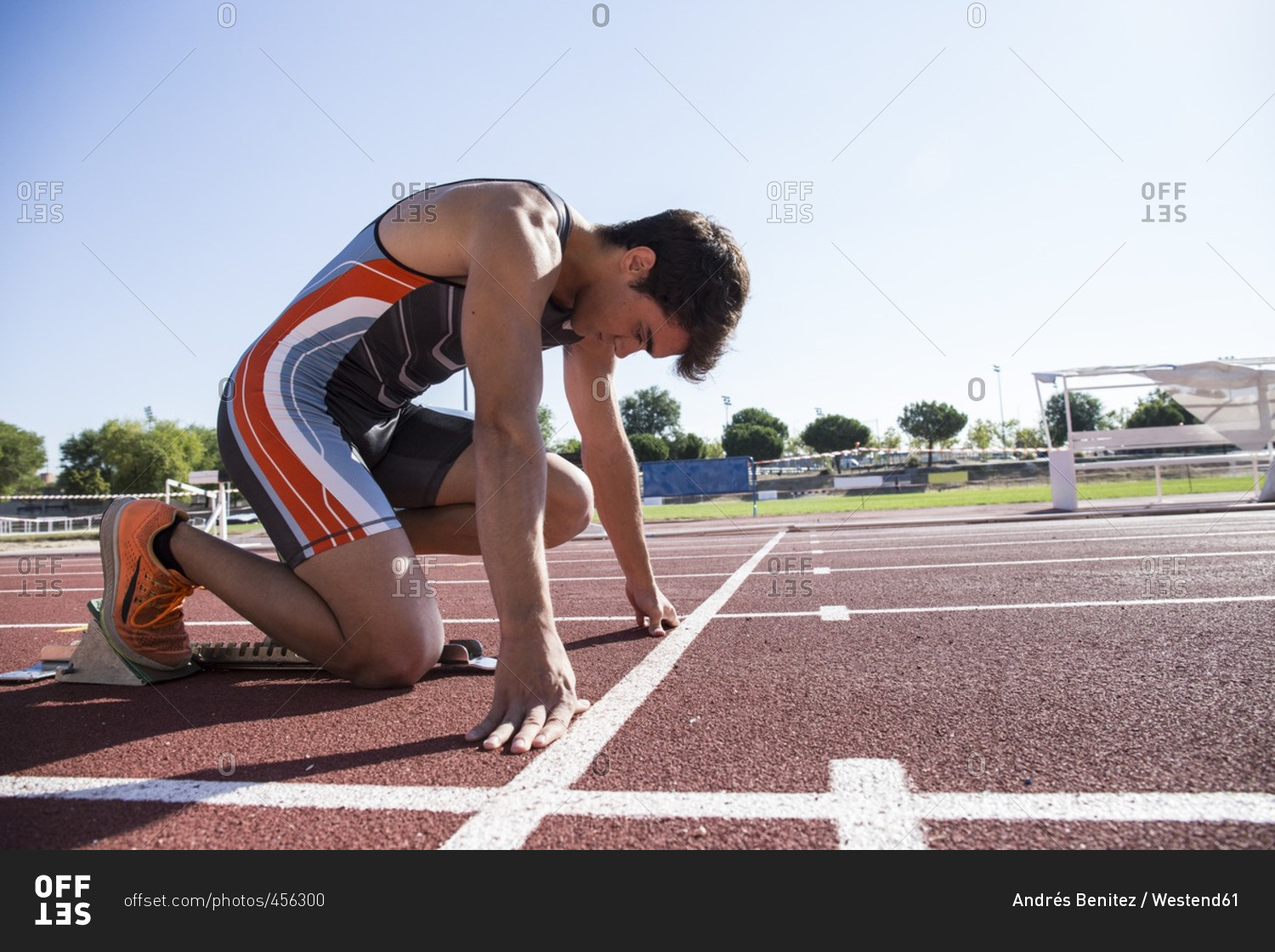 Runner on tartan track in starting position