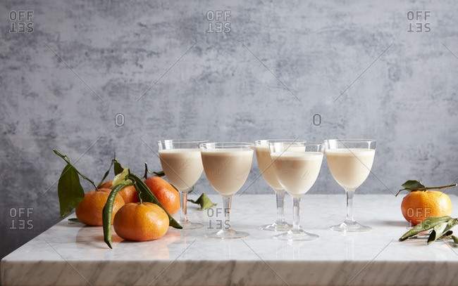 Cocktails in goblets by oranges