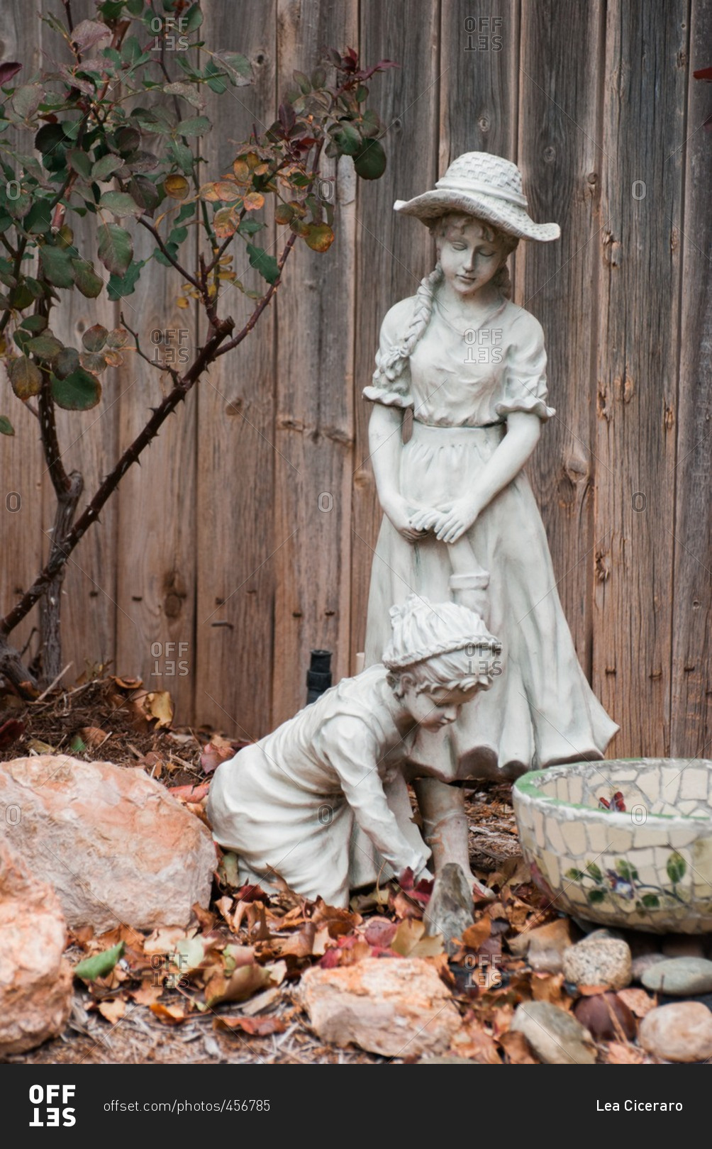 Backyard statue of little girls and a bird bath