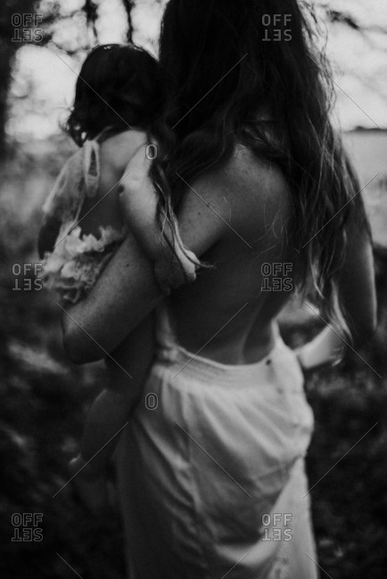 Mother walking with daughter outdoors in black and white