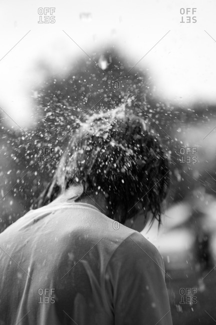 Water splashing on boys head