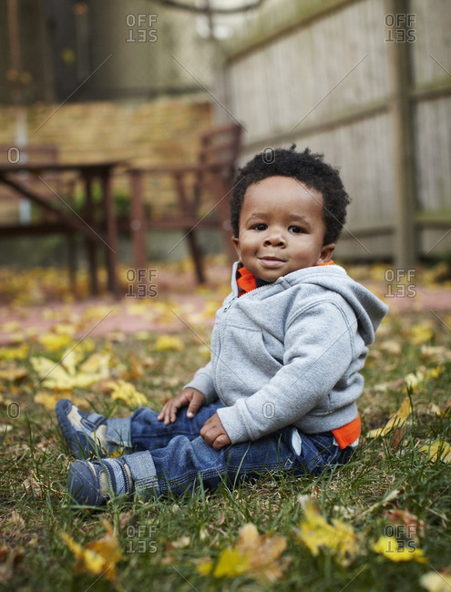 African American baby sitting in grass